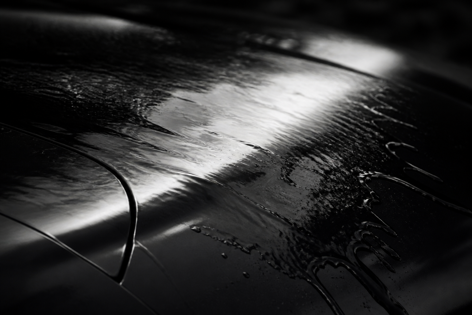 Water moving across dark paint.
